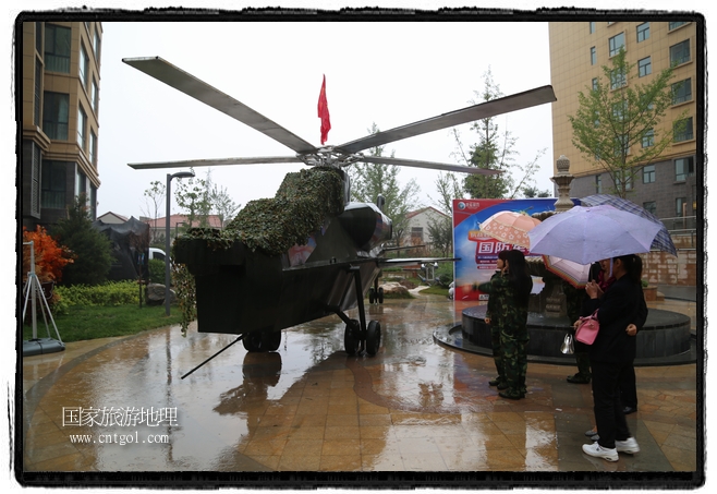 小區(qū)突然出現(xiàn)“飛機(jī)坦克”，其中殲15艦載戰(zhàn)斗機(jī)一架、99式主戰(zhàn)坦克一輛、武直-10武裝直升機(jī)一架，吸引了眾多市民雨中圍觀、合影。